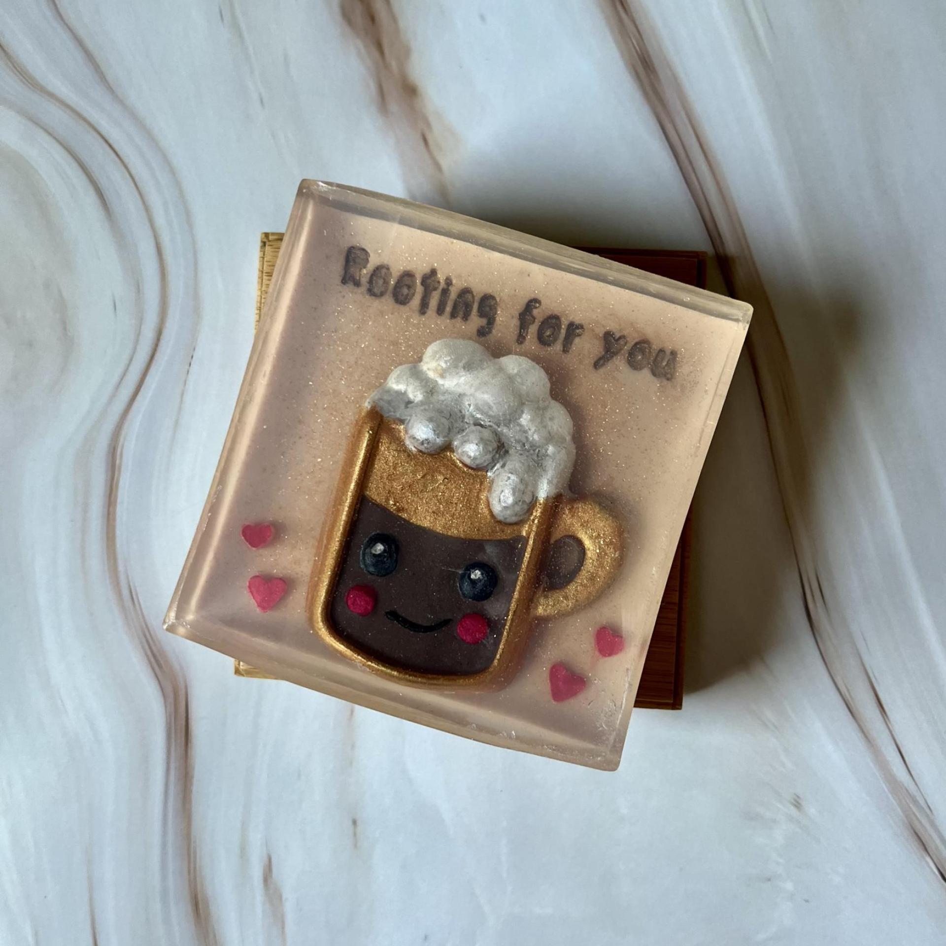 Handmade soap with a cute kawaii root beer mug with hearts that reads “rooting for you”