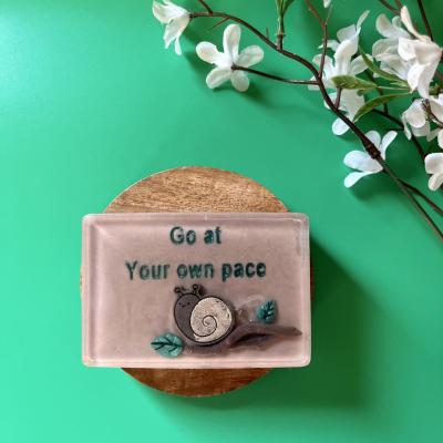 Handmade soap with cute kawaii snail on a branch that reads “go at your own pace”