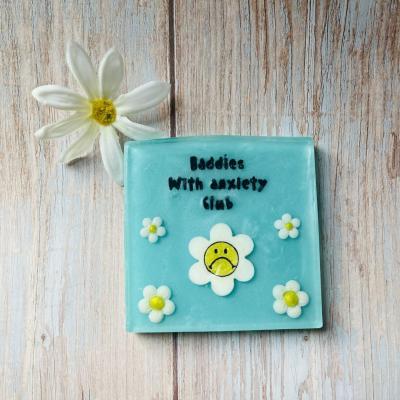 Handmade soap with sad daisy flower that reads “baddies with anxiety club”